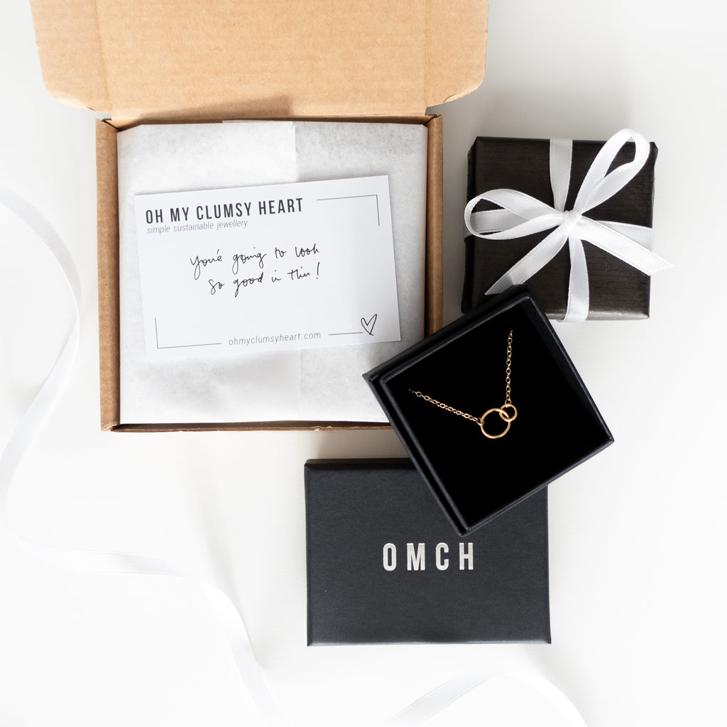 Jewelry box with a necklace and a card inside, on a white background
