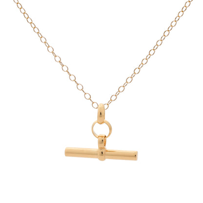 Gold necklace with a t-bar pendant on a white background