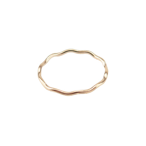 A gold stacking ring with a wave design on a white background.